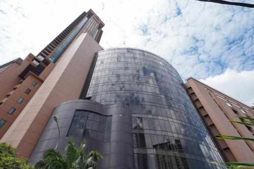 a tall glass building with a sky at OYO 90106 Sindbad Hotel in Kuala Lumpur