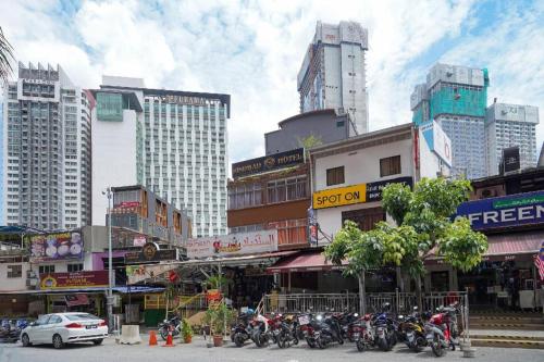 a group of motorcycles parked on a street in a city at OYO 90106 Sindbad Hotel in Kuala Lumpur