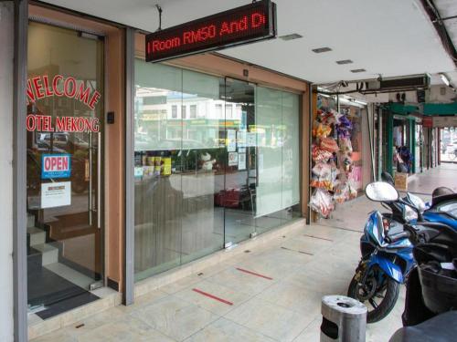 a store front with motorcycles parked outside of it at OYO 90173 Hotel Mekong in Kuala Lumpur