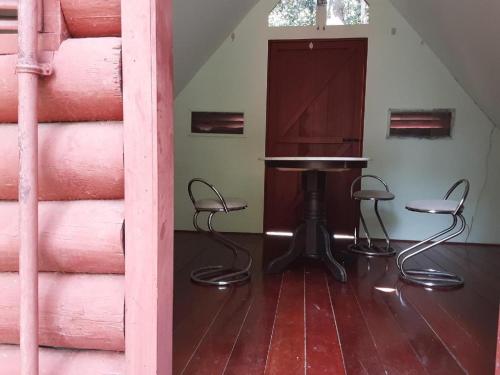 a room with a table and chairs in a room at SPOT ON 90536 Bens Maju Foreststay in Melaka