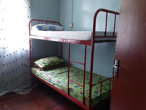 a bedroom with two bunk beds in a room at SPOT ON 90536 Bens Maju Foreststay in Melaka