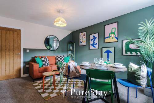 a living room with a table and a couch at Lovely 3 Bedroom House in Grimsby with WiFi & Parking Sleeps7 by PureStay in Grimsby