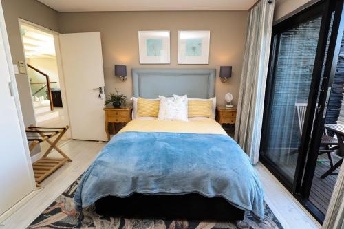 a bedroom with a bed and a large window at Sea Dreams Guesthouse in Ballito