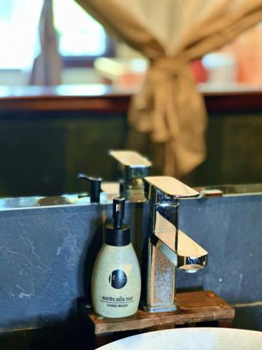 a couple of soap dispensers sitting on a sink at Pu Luong Jungle Lodge in Pu Luong