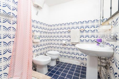 a bathroom with a toilet and a sink at Campo Felice Apartment in Casamaina