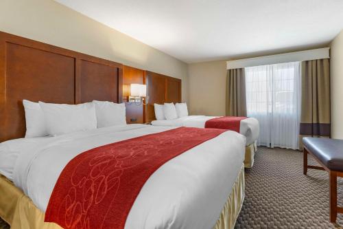 a hotel room with two beds and a window at Comfort Suites Phoenix Airport in Tempe