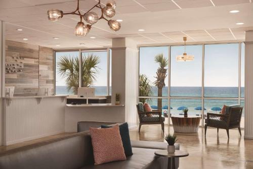 a living room with a view of the ocean at Radisson Beachfront Hotel - Panama City Beach in Panama City Beach