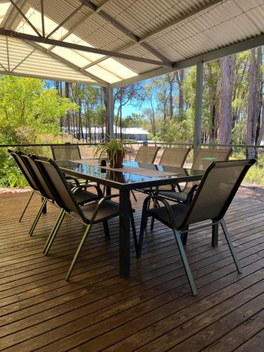 a glass table and chairs on a deck at Diamond Lake Escape in Collie