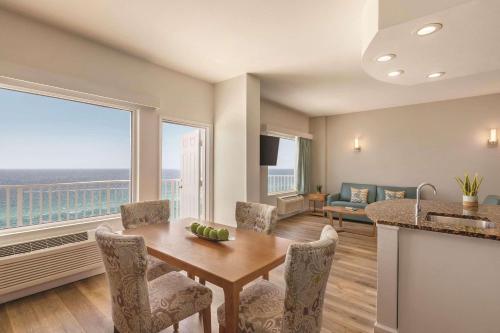 a dining room with a table and a view of the ocean at Radisson Beachfront Hotel - Panama City Beach in Panama City Beach