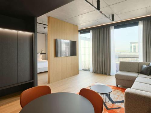 a living room with a couch and a table at Pullman Zagreb in Zagreb