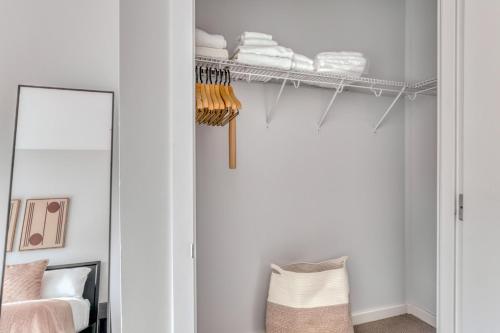 a white closet with a mirror and towels at Soma 2br w pet spa gym on-site yoga SFO-1479 in San Francisco