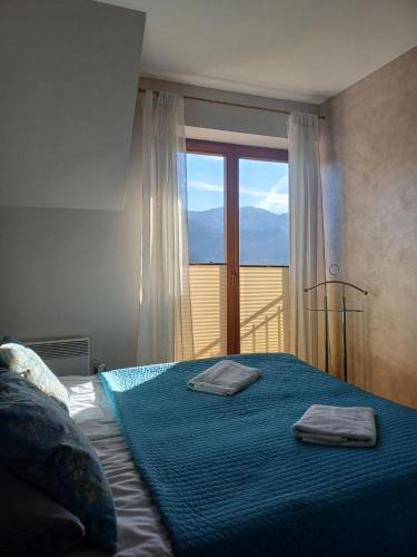 a bedroom with a bed with two towels on it at Apartament Kasprowy in Kościelisko