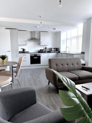 a living room with a couch and a table at Ascot House Apartments in Peterborough