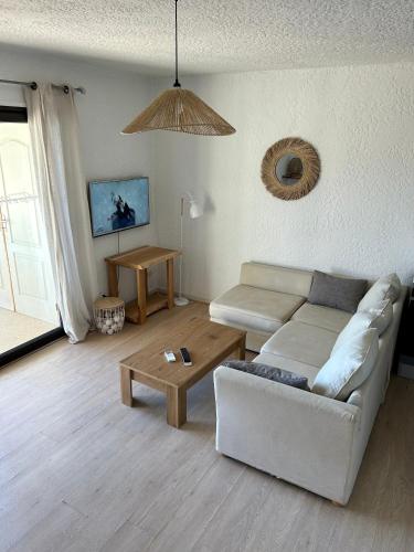 a living room with a couch and a coffee table at Residence Roc E Mare Cargèse in Cargèse