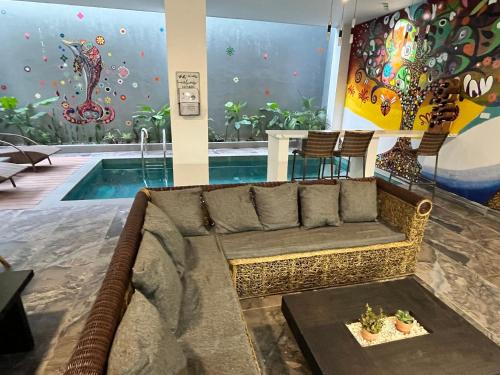 a living room with a couch and a swimming pool at Serene Villa Icaro in Downtown El Nido with Cliff View in El Nido