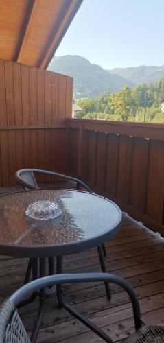 a table and chairs sitting on a deck with a view at Alpin Apartments in Maria Alm am Steinernen Meer