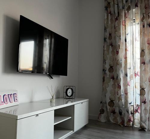 a living room with a tv on the wall at Noemie Apartmani in Zagreb