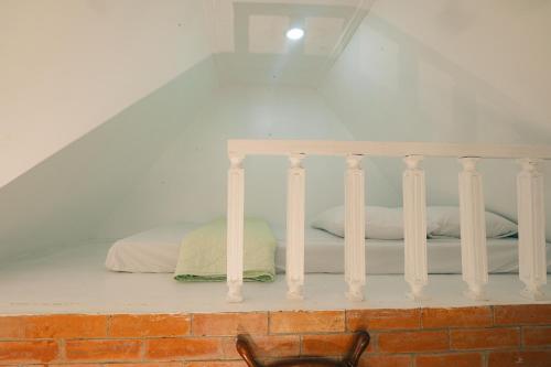 a room with a bed with white pillows on it at Playa las Flores in Zambales
