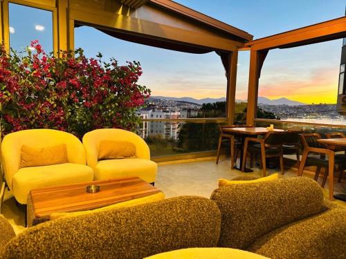a living room with yellow furniture and a view of a city at Monalisa Hotels KUŞADASI in Kusadası