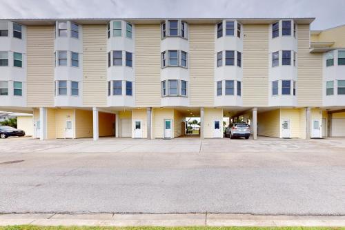 a large apartment building with a parking lot at Smiles and Sunsets in Oak Grove