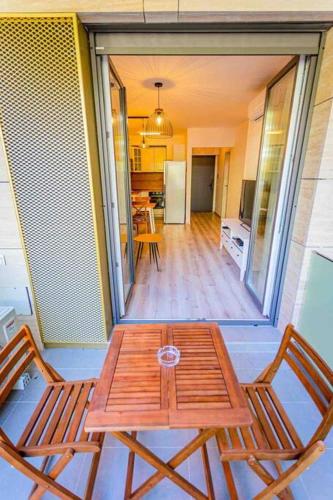 a wooden table and two chairs in a room at Corvin Luxury Quiet Cabin in Budapest