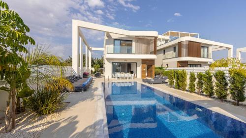 an image of a house with a swimming pool at Nissi Residences Villa 4 in Ayia Napa