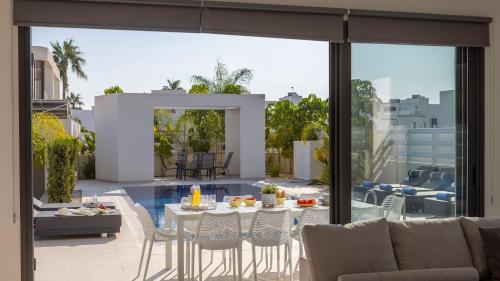 a patio with a table and chairs on a balcony at Nissi Residences Villa 4 in Ayia Napa