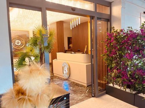 a lobby with a mirror and flowers in a store at Monalisa Hotels KUŞADASI in Kusadası
