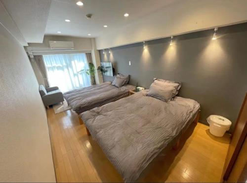 a bedroom with two beds and a large window at shinjuku yuki okubo 502-SJ0044 in Tokyo