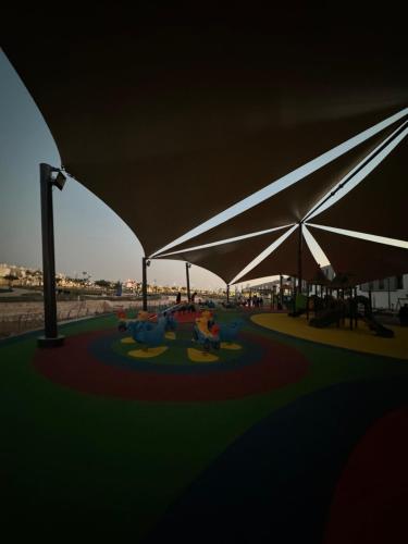 a rendering of a playground with white umbrellas at Small details2 Self-check-in in Riyadh