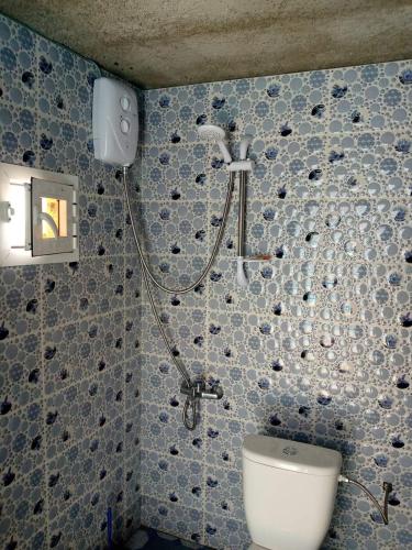 a bathroom with a shower and a toilet at The Endless Enigma in Tazroutane