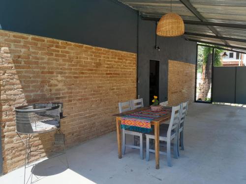 a table and chairs in a patio with a brick wall at Casa Azul in Villa del Dique