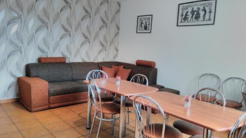 a living room with two tables and a couch at Guest House Kovalik in Suchá Hora