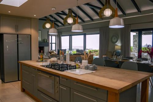 a kitchen with a kitchen island with a counter top at Luxury Beach House in Romansbaai Estate in Gansbaai