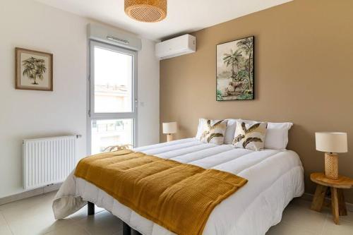a bedroom with a large bed with a yellow blanket on it at Le Bohème Classé 3 étoiles in La Londe-les-Maures