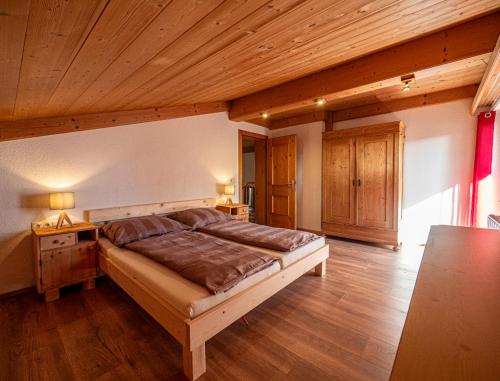 a bedroom with a bed and a wooden ceiling at Ferienwohnung Zillertal - Schwemberger in Fügen