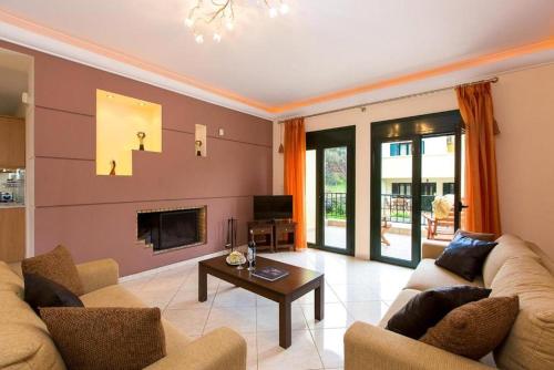 a living room with two couches and a fireplace at Argyro Villa in Balíon