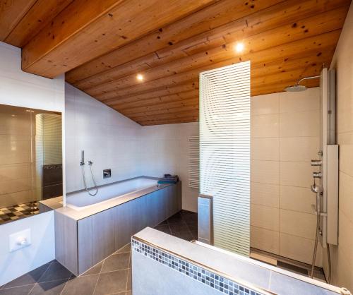 a large bathroom with a tub and a shower at Ferienwohnung Zillertal - Schwemberger in Fügen