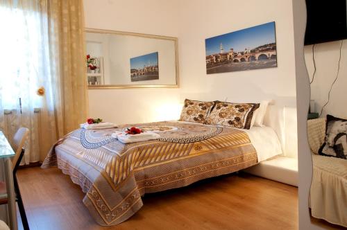 a bedroom with a bed with two towels on it at Arena d'Intorno in Verona