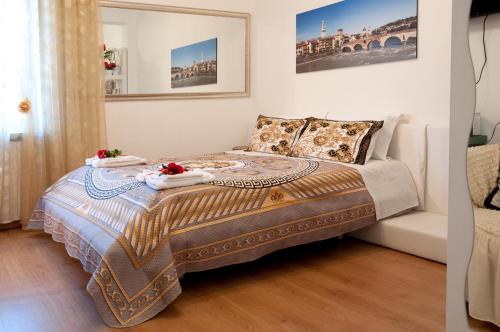 a bedroom with a bed with two towels on it at Arena d'Intorno in Verona