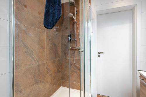 a bathroom with a shower with a glass door at Ferienwohnung Lueg Ins Wiesental in Steinen