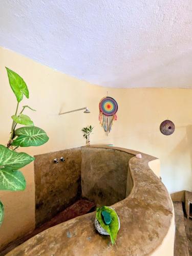 a room with a bird sitting on top of a tub at Butterfly Space- A Non-Profit Eco-Lodge in Nkhata Bay