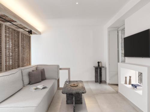 a living room with a couch and a table at Canaves Epitome - Small Luxury Hotels of the World in Oia