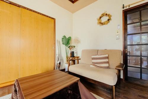 a living room with a chair and a table at yururito guesthouse in Matsumoto