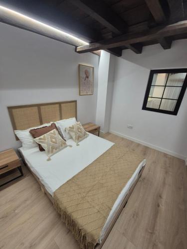 a bedroom with a large bed in a room at Casa La tranca in Cuevas del Valle