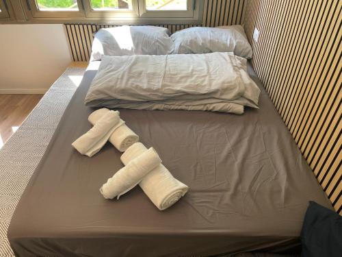 a bed with two towels and two pillows on it at Little Milan - LM2 - LM3 - LM4 in Milan