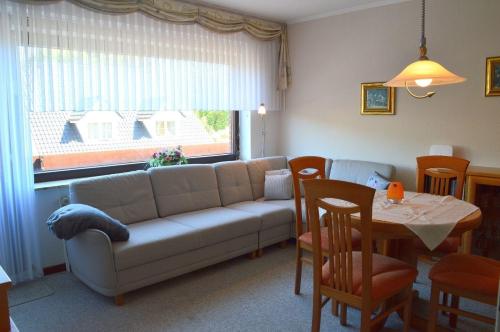 a living room with a couch and a table at Wiesenweg - Wohnung 06 in Wyk auf Föhr