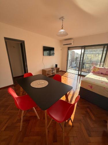 a room with a table and chairs and a bed at Aloha II in Rosario