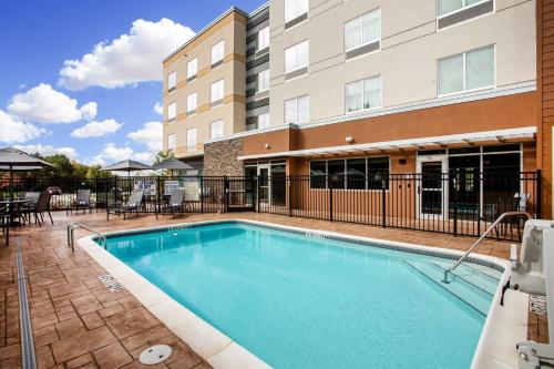 a swimming pool in front of a building at Fairfield Inn & Suites by Marriott Greenville Spartanburg/Duncan in Duncan
