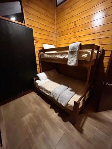 a room with bunk beds in a wooden wall at Eco Casa Mango Lepanto #10 in Lepanto